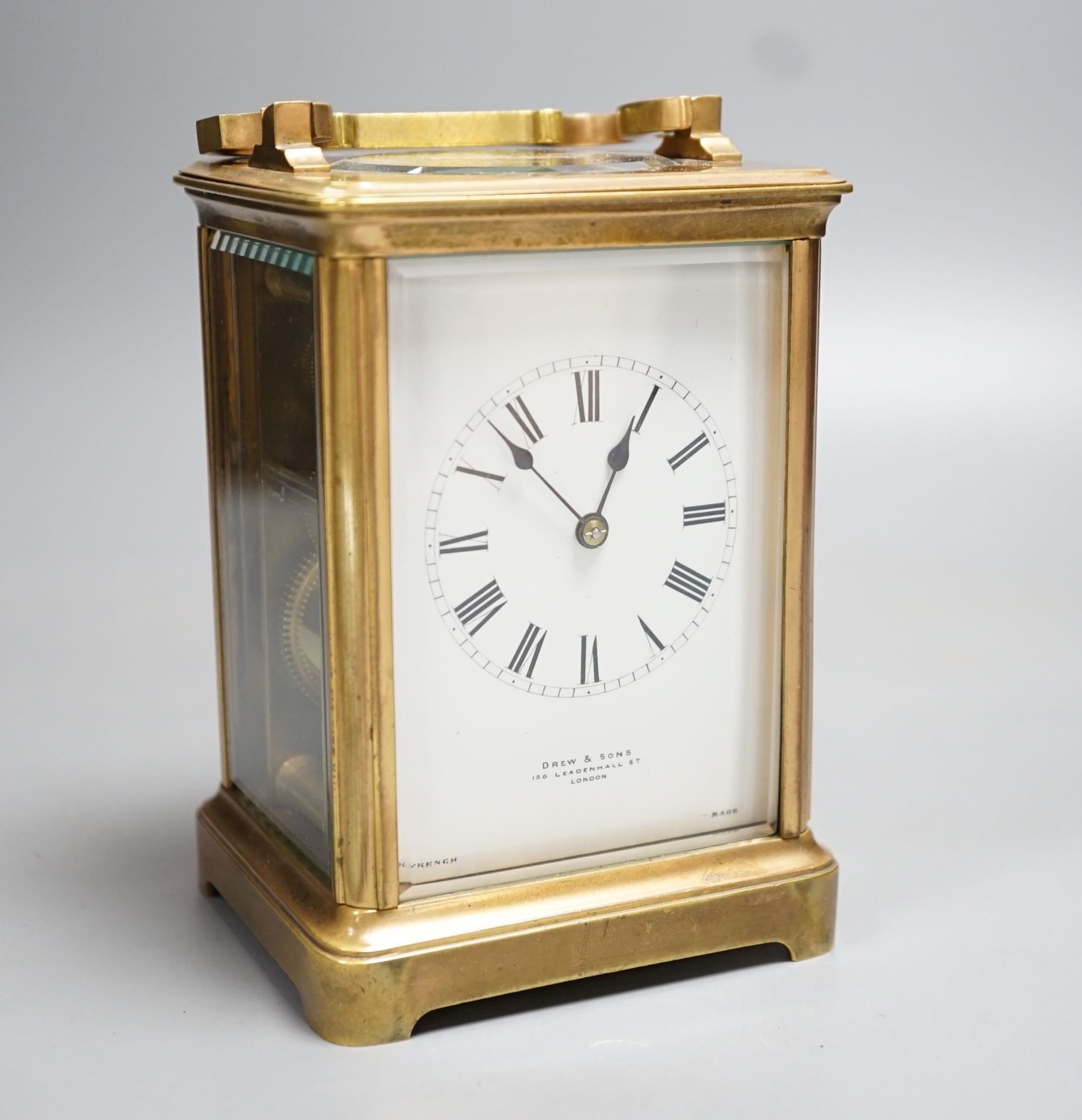 A French brass carriage clock, retailed by Drew and Sons, 166 Leadenhall Street London. 14.5cm (handle down)